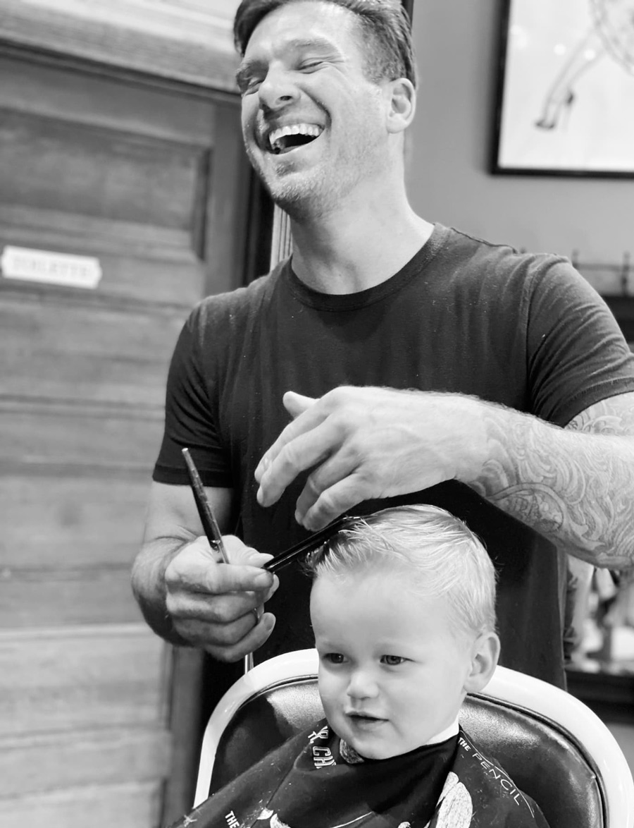 man giving child a haircut