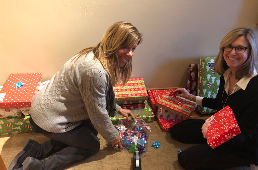 Two ladies opening gifts