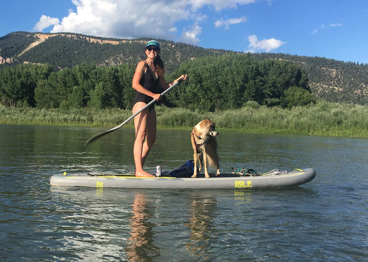 Girl on paddle board with dog