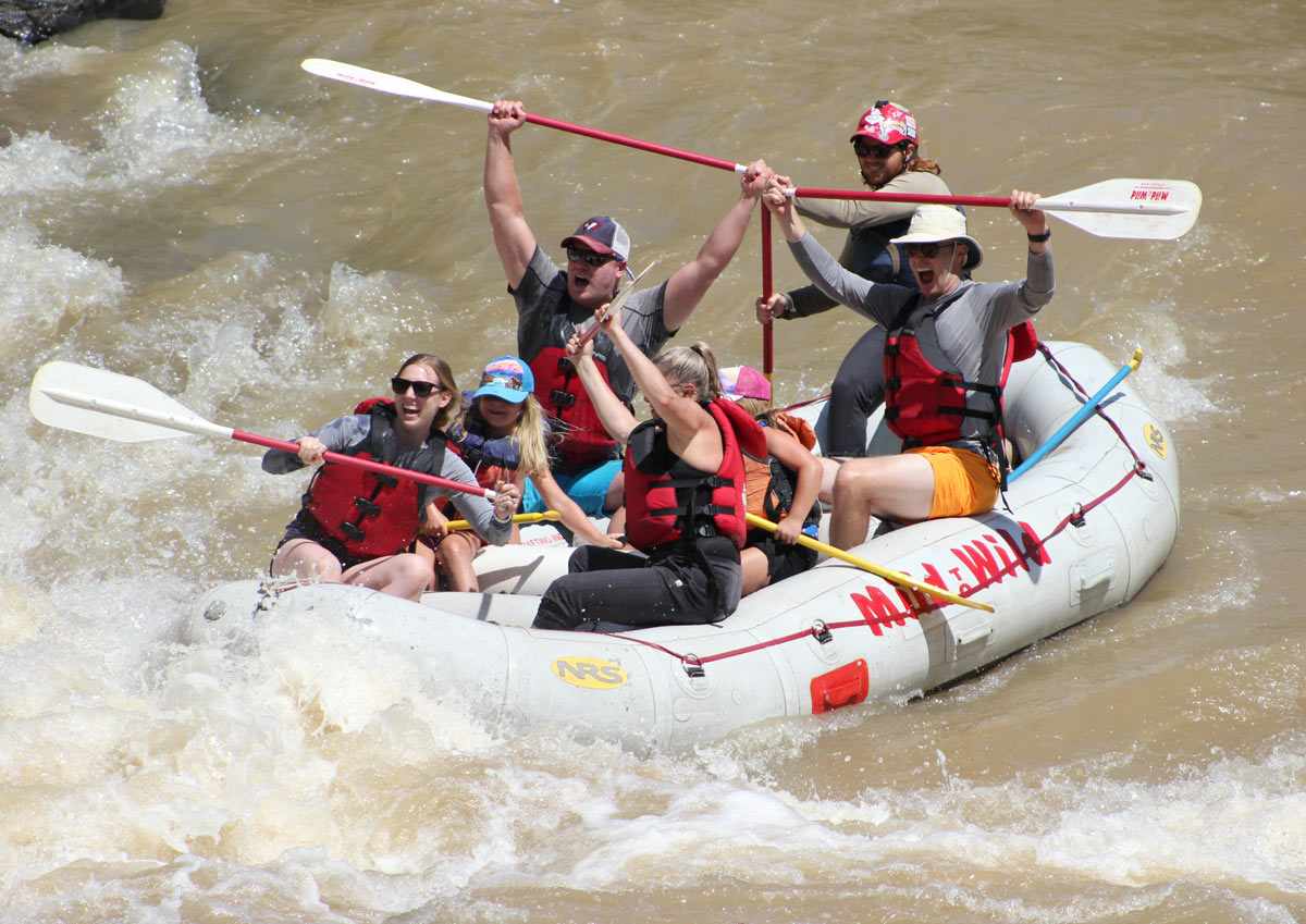 group of people rafting down a river